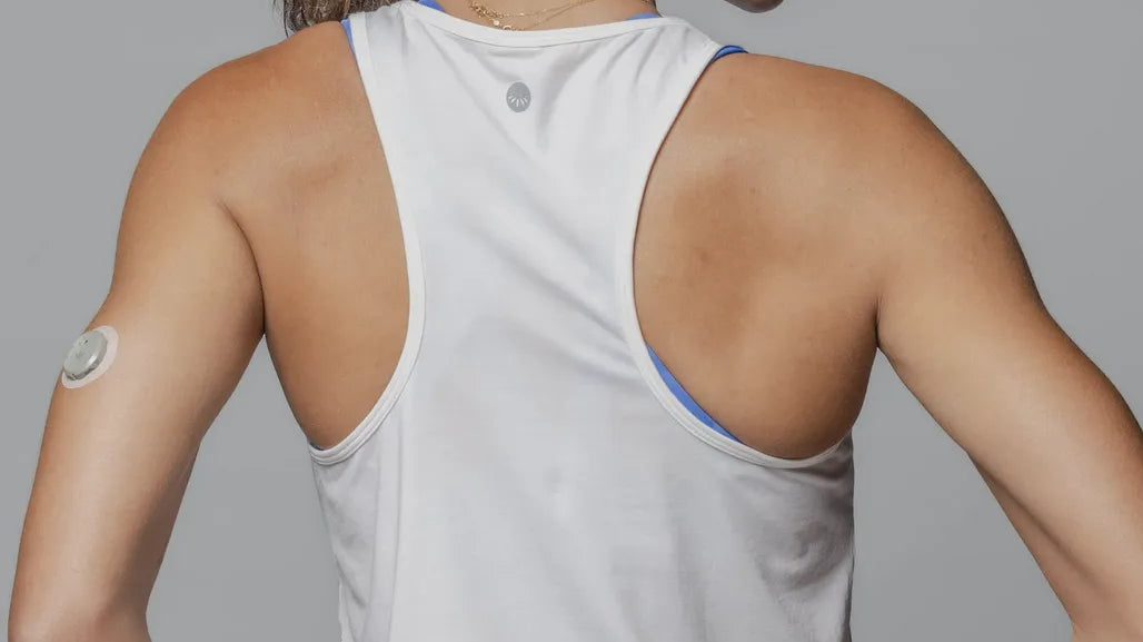 Back view of woman wearing Everyday Tank - White with blue leggings
