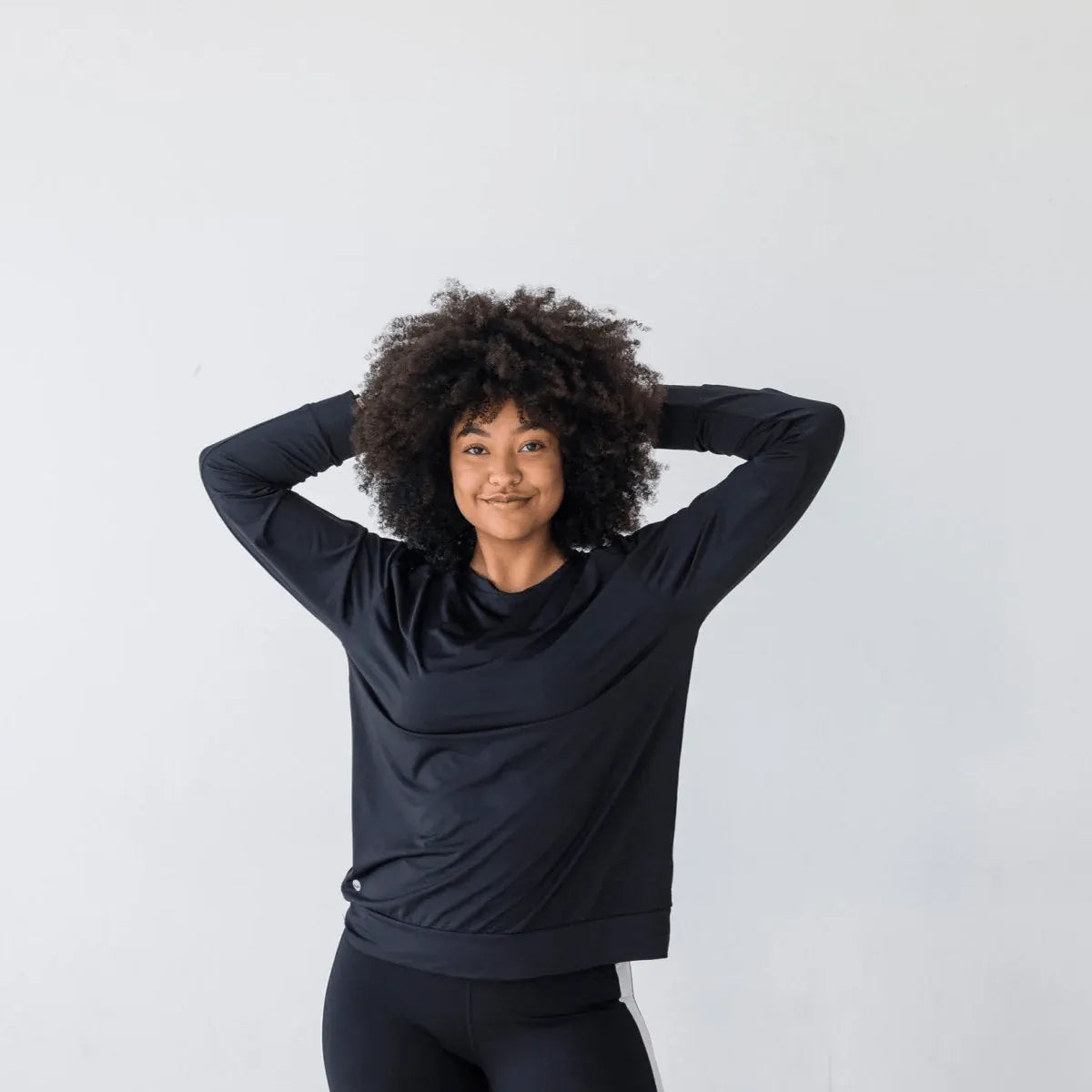 Woman smiling wearing Laser Cut Pullover - Black